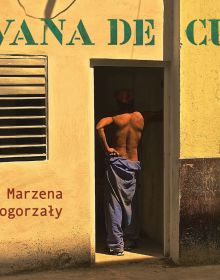 Cuban male in blue trousers standing with his back to viewer in building doorway, 'HAVANA DE CUBA', in green stencilled font above.