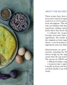 Two plates of food filled breads, 'Georgian Khachapuri and Filled Breads', in cream font below, by Pallas Athene.