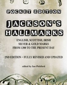 Stamped antique silver with decorative leaf design, on cover of 'Jackson’s Hallmarks, Pocket Edition', by ACC Art Books.