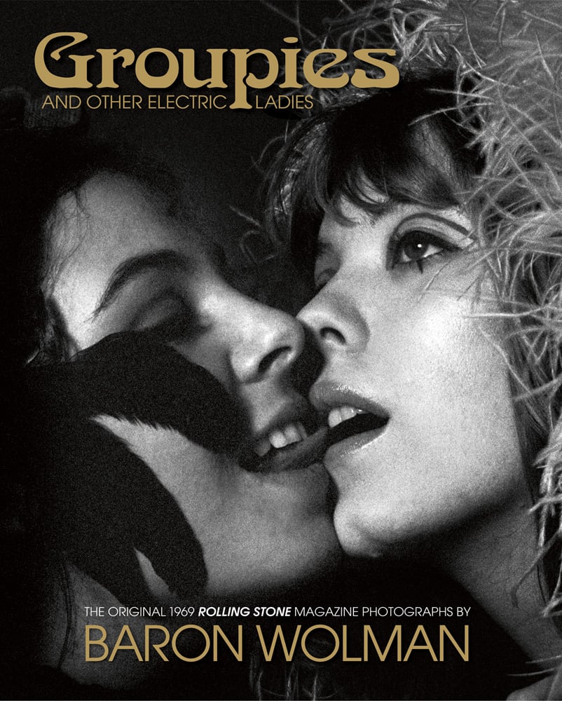 Book cover of Groupies and Other Electric Ladies, featuring two women; one with tongue near the others mouth. Published by ACC Art Books.