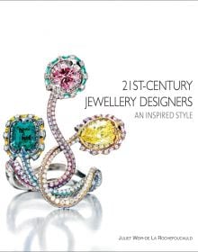 Small diamond encrusted jewelry piece with three larger gemstones, on cover of '21st-Century Jewellery Designers An Inspired Style', by ACC Art Books.