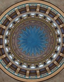 Book cover of An American Renaissance: Beaux-Arts Architecture in New York City, with low angled shot of interior ceiling dome with white and gold plaster. Published by Images Publishing.