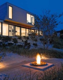 Book cover of Beautiful Beach Houses: Living in Stunning Coastal Escapes, with a bright interior of beach house with sea view through windows. Published by Images Publishing.