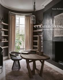 Book cover of Curated Living: Elegant Interiors and Artful Homes, featuring an interior living room with wood table and beige drapes. Published by Images Publishing.