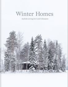 Book cover of Winter Homes: Stylish Living for Cool Climates, with a cabin obscured by snow-covered forest trees. Published by Images Publishing.