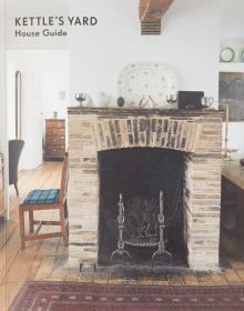 Interior of Kettle's Yard room with brick fire place, wood floor, on cover of 'Kettle's Yard House Guide', by Kettle's Yard, University of Cambridge.