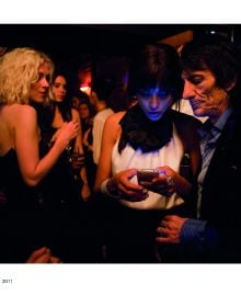 Group of women looking at their mobile phones, their faces illuminated, on cover of 'Screen Time', by Circa Press.