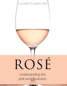 Book cover of Elizabeth Gabay's Rosé, Understanding the Pink Wine Revolution, with a wine glass of Rose on table. Published by Academie du Vin Library.