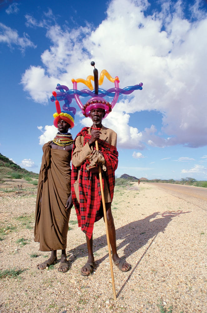 Book cover of Inflatable Planet, with two men in traditional dress, with one leaning on stick, both wearing inflated balloon crowns on their heads. Published by ORO Editions.