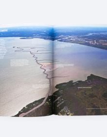 Book cover of The Dredge Research Collaborative's Silt Sand and Slurry: Dredging, Sediment, and the Worlds We Are Making, with aerial view of sandy land with water. Published by ORO Editions.