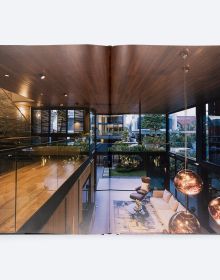 Book cover of The Space Between, with a roofless inner courtyard with swimming pool surrounded by tropical palms. Published by ORO Editions.