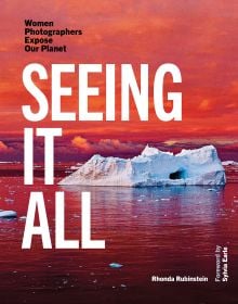 Book cover of Seeing It All, Women Photographers Expose our Planet, with a large iceberg floating on sea, under orange sky. Published by ORO Editions.