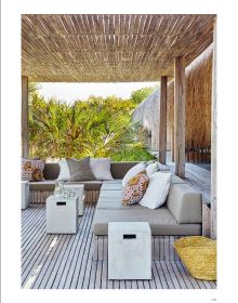 Modern building with flat roof surrounded by long green grass, on white cover of 'Paradise Found, Exceptional Homes in Extraordinary Places', by Beta-Plus.