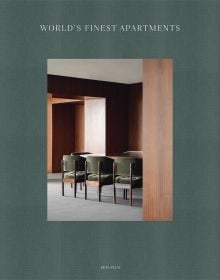 Green linen book cover of World's Finest Apartments, with interior dining space with dark wood veneered walls, long table with green, velvet covered chairs. Published by Beta-Plus.