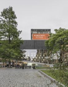 Book cover of OMA’s Kunsthal in Rotterdam, Rem Koolhaas and the New Europe, with two construction site workers standing on roof of building. Published by Park Books.