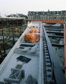 Book cover of OMA’s Kunsthal in Rotterdam, Rem Koolhaas and the New Europe, with two construction site workers standing on roof of building. Published by Park Books.