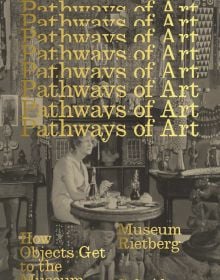 Book cover of Pathways of Art: How Objects Get to the Museum, with a woman sitting at table smoking a cigarette, surrounded by African art. Published by Scheidegger & Spiess.