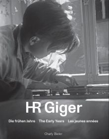 Book cover of HR Giger: The Early Years, with a young Giger playing with a train set. Published by Scheidegger & Spiess.