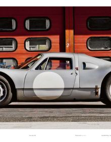 Aerial shot of black Porsche 904 Carrera GTS, number 122 in white on bonnet and boot, on cover of 'Porsche 904', by Delius Klasing.