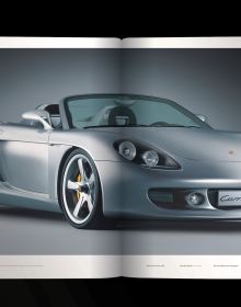 Book cover of Porsche Carrera GT, with a gray sportscar driving on roads around mountainous landscape. Published by Delius Klasing Verlag GmbH.