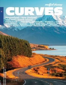 Book cover of Stefan Bogner's CURVES New Zealand: Volume 22, with a winding road on the coast, with snow covered mountains behind. Published by Delius Klasing.