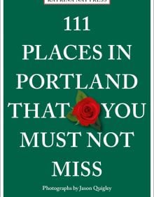 Red rose near centre of green cover of '111 Places in Portland That You Must Not Miss', by Emons Verlag.