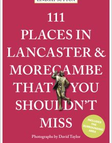 Bronze statue of Eric Morecambe near centre of red cover of '111 Places in Lancaster and Morecambe That You Shouldn't Miss', by Emons Verlag.