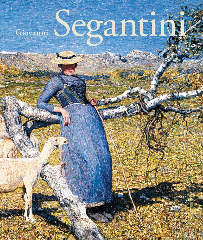 Book cover of Giovanni Segantini, with a painting titled Afternoon in the Alps, 1892, with a women in blue dress leaning against tree branch with lamb to her right. Published by Scheidegger & Spiess.