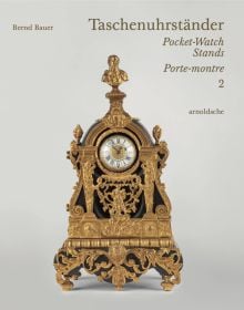 Book cover of Taschenuhrständer – Pocket-Watch Stands – Porte-montre, with an ornate pocket watch stand featuring a green bird to top. Published by Arnoldsche Art Publishers.