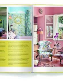 Large rattan chair draped with mustard coloured ceiling fabric, floppy hats on wall, on yellow cover of 'Boho Style, Bohemian Home Inspiration', by teNeues Books.