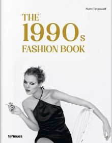 Book cover of The 1990s Fashion Book', with model Kate Moss wearing a black silk dress, sitting on white chair, smoking a cigarette. Published by teNeues Books.