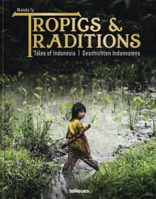 Book cover of Manolo Ty's Tropics & Traditions: Tales of Indonesia, with a young child walking through a river. Published by teNeues Books.