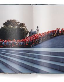 Book cover of Xiomara Bender's Waiting for the Rainbow: Ten Years in North Korea, with a group of dancers lining up in red costumes. Published by teNeues Books.