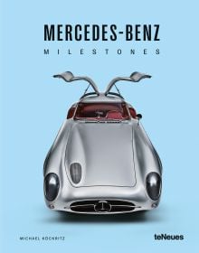 Book cover of Michael Köckritz's car guide, Mercedes-Benz Milestones, featuring a silver Mercedes-Benz 300 SLR gullwing Uhlenhaut, with doors open. Published by White Star.