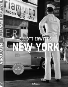 Man wearing white sailor's clothes and hat, with his back to viewer, staring across busy city street, on cover of 'Elliott Erwitt’s New York', by teNeues Books.