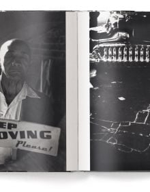 Man wearing white sailor's clothes and hat, with his back to viewer, staring across busy city street, on cover of 'Elliott Erwitt’s New York', by teNeues Books.