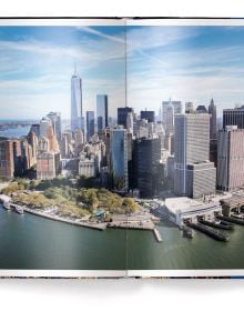 Book cover of BIG NEW YORK: The Most Iconic Photos, with the evening city skyline behind a large stencil of title. Published by teNeues Books.