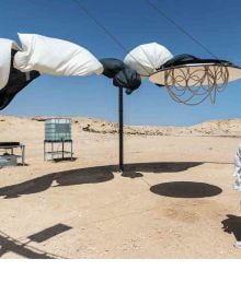 Book cover of Olafur Eliasson: The Curious Desert, with the desert floor seen through an optical device. Published by Silvana.