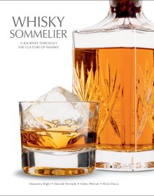 Book cover of Whisky Sommelier, A Journey Through the Culture of Whisky', with a glass of whisky with an ice cube, and crystal decanter. Published by White Star.