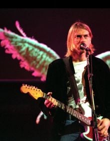 Book cover of Kurt Cobain: The Fallen Angel of Rock 'N' Roll, with an iconic image of the singer wearing thick, black eyeliner, staring into the camera. Published by White Star.