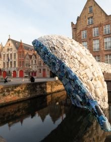 Book cover of 2018 Bruges Triennial: Liquid City, with a large red and yellow cocoon installation, floating on water with locks. Published by Stichting Kunstboek.