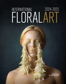 Book cover of International Floral Art 2024-2025, featuring a model with streams of flower petals dangling from eye lashes. Published by Stichting Kunstboek.