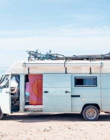 Book cover of Van Life: Culture, Vehicles, People, Places, with white and green camper van parked by the seaside, figure looking out to sea. Published by Lannoo Publishers.