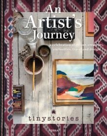 Book cover of An Artist’s Journey: A Celebration of Colour, Creativity, Curiosities, Travel and Design, with a table of paintings, pastels and paintbrushes. Published by Lannoo Publishers.