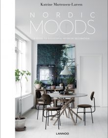 Minimalist dining interior, table and chairs, low light fixing, white walls, on cover of 'Nordic Moods', by Lannoo Publishers.