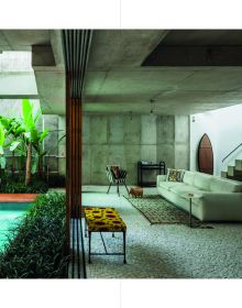 Relaxing exterior space with small pool surrounded by green exotic palm trees, on cover of 'Botanical Buildings, When Plants Meet Architecture', by Lannoo Publishers.