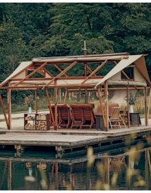 Book cover of Outdoor Interiors, with an outside seating area of Tehama 1 House in California, with fireplace. Published by Lannoo Publishers.