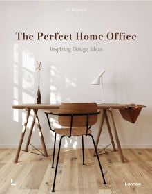 Book cover of An Bogaerts' The Perfect Home Office: Inspiring Design Ideas, with wooden desk with white lamp, and chair. Published by Lannoo Publishers.