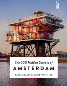 Book cover of The 500 Hidden Secrets of Amsterdam, with REM Island, with sea platform on stilts housing a restaurant. Published by Luster Publishing.