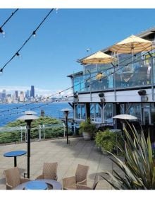 Book cover of The 500 Hidden Secrets of Seattle with the Pike Place market unlit neon sign above corrugated roof. Published by Luster Publishing.